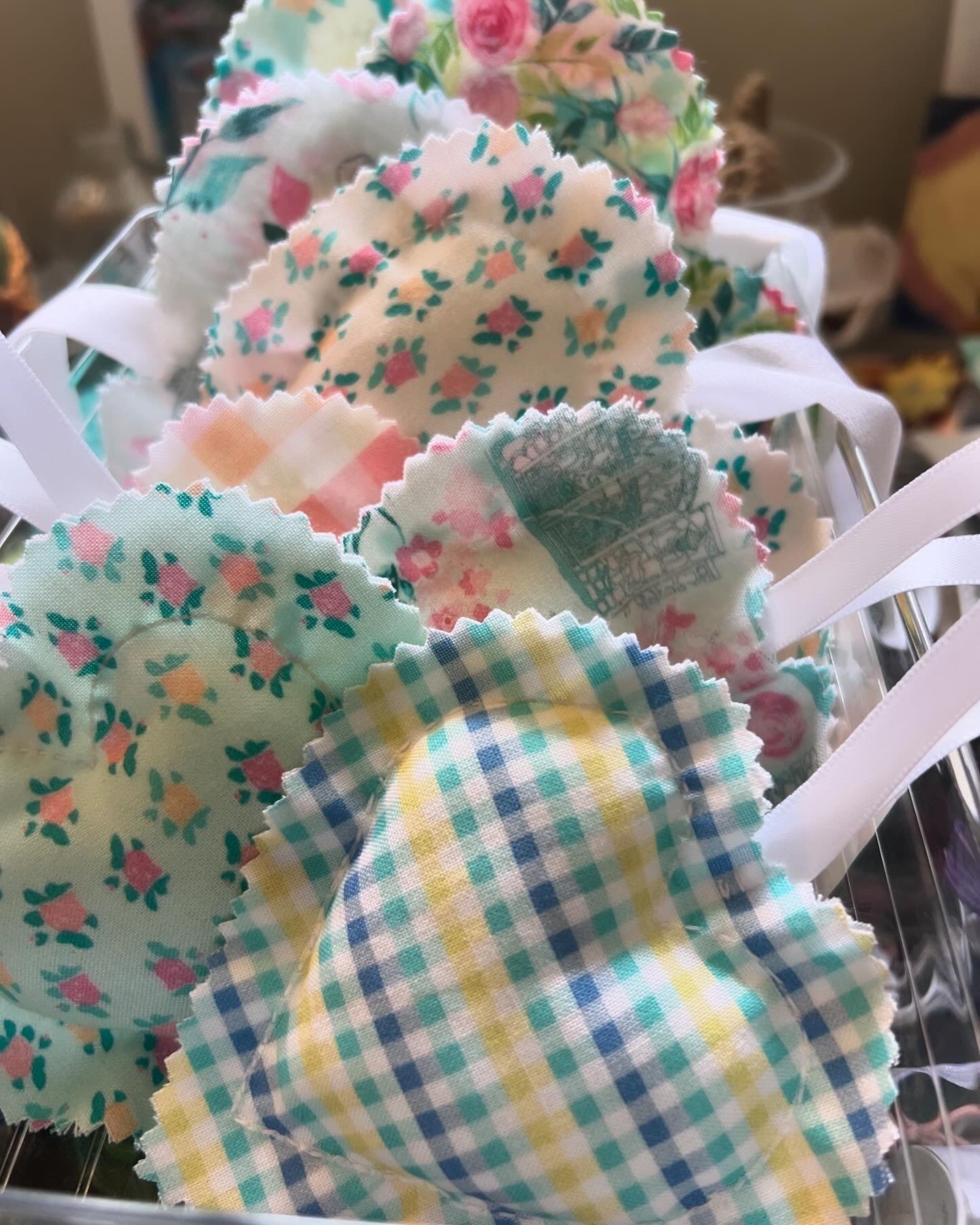 Eight handstitched soft hearts in assorted print fabric stuffed with poly fiber.