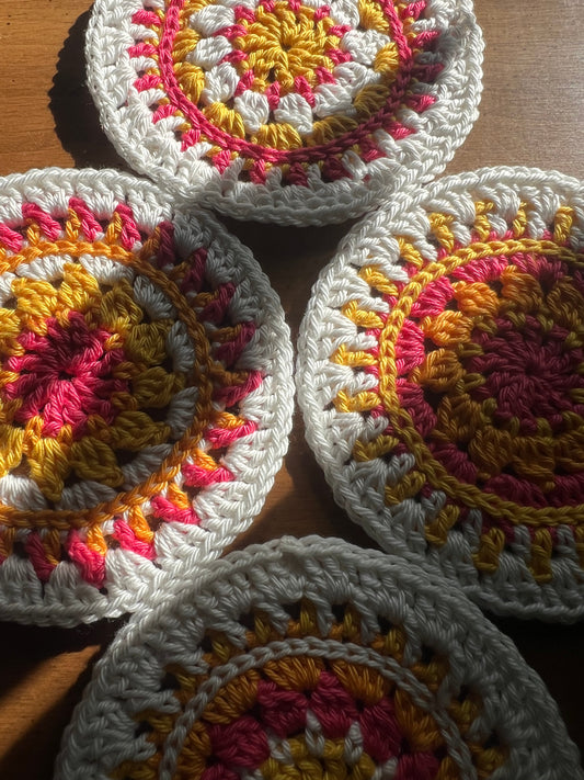 Crochet mini mandala art coasters in lemon, creme, strawberry, and mango. (Sold as 2-piece sets: you select 2 pieces. Specify the center color and petals. Pick 2 offering.)