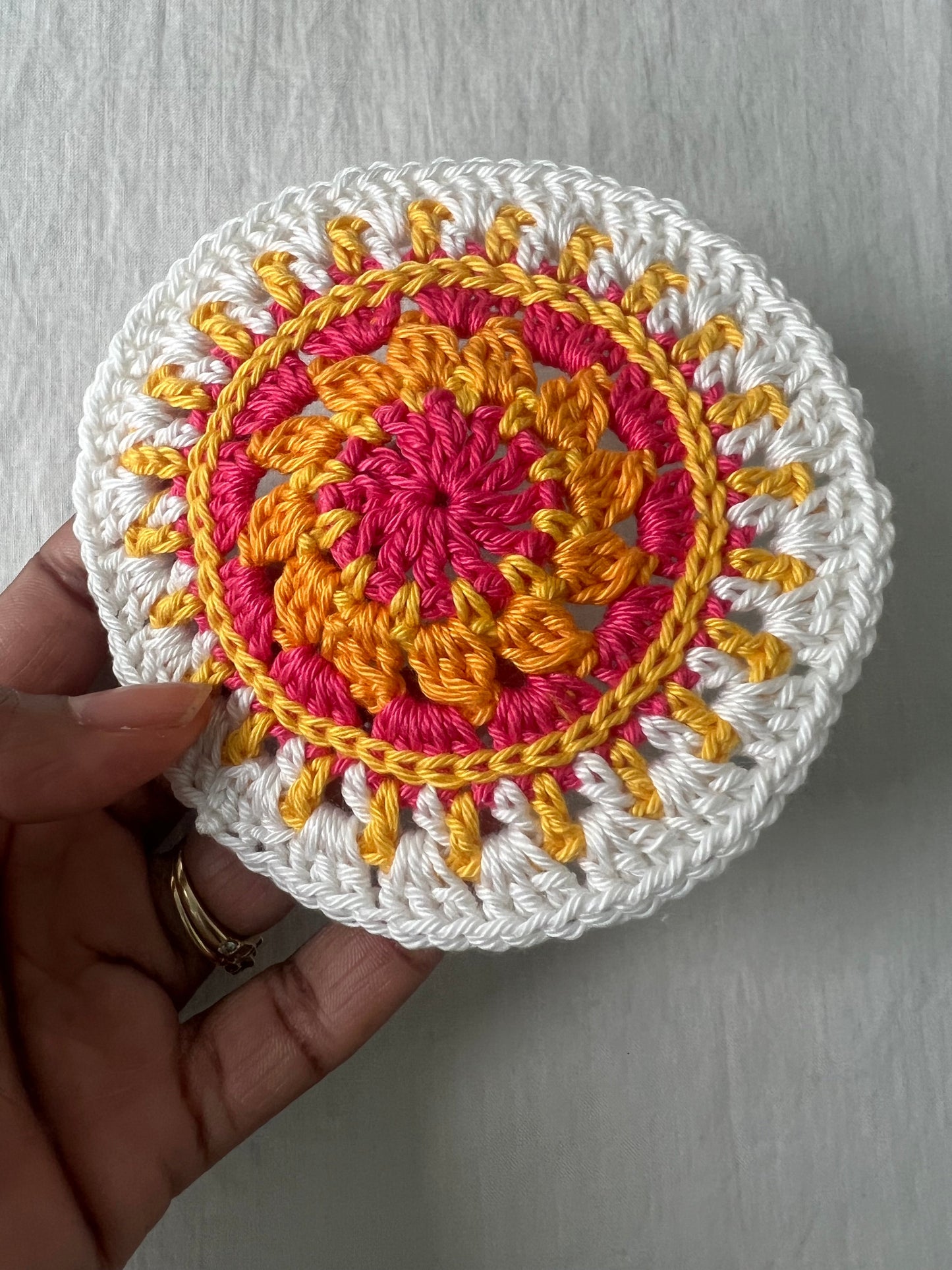 Crochet mini mandala art coasters in lemon, creme, strawberry, and mango. (Sold as 2-piece sets: you select 2 pieces. Specify the center color and petals. Pick 2 offering.)